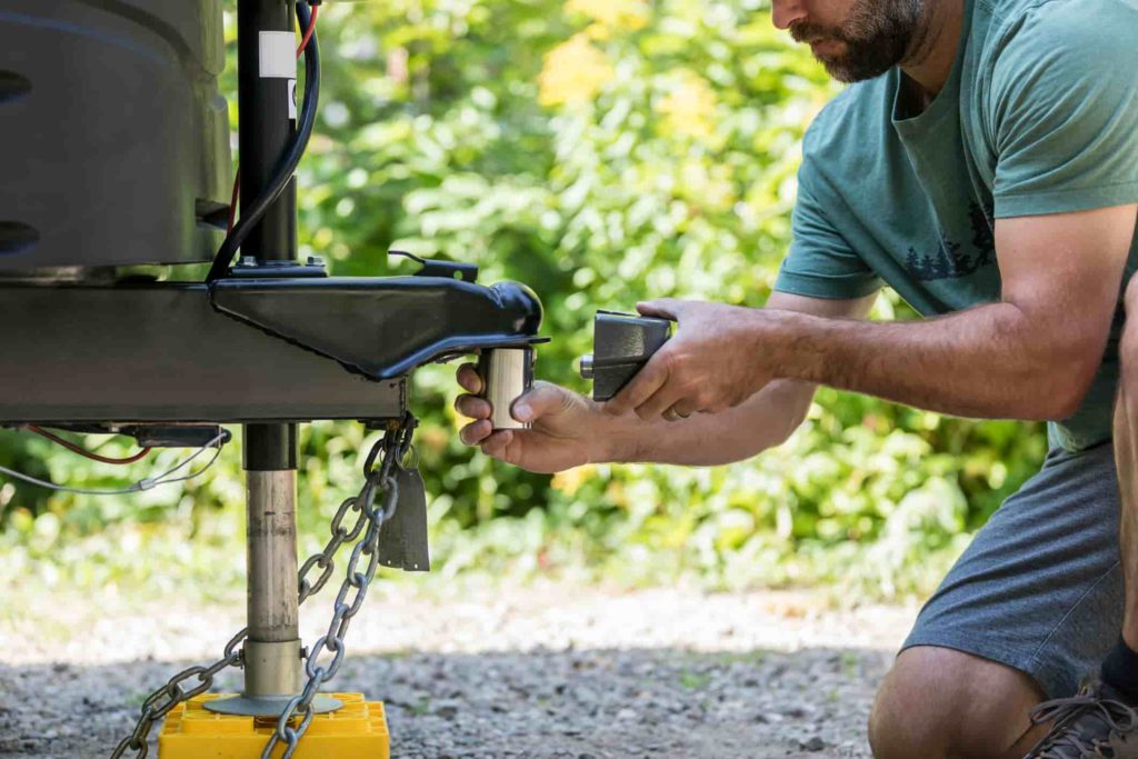 Man examining tow hitch