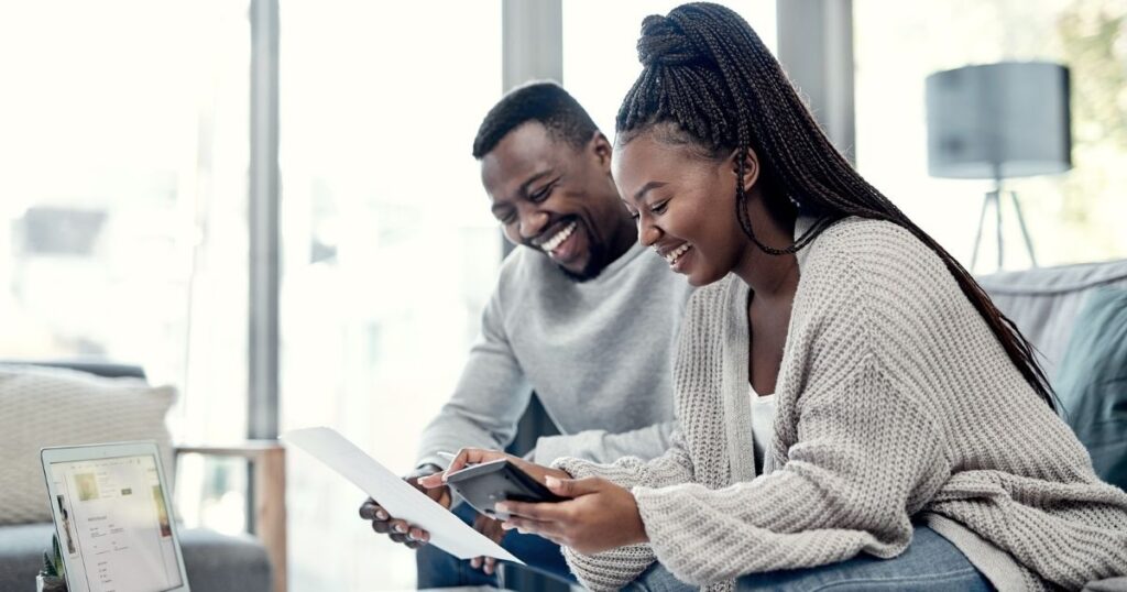 A man and woman looking at their insurance claim