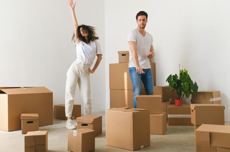 Couple dancing around moving boxes