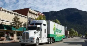 A green and white Mayflower moving truck.