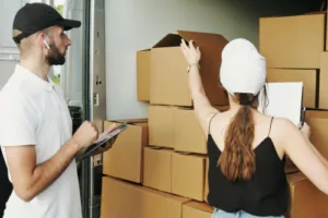 Two people loading a moving van.